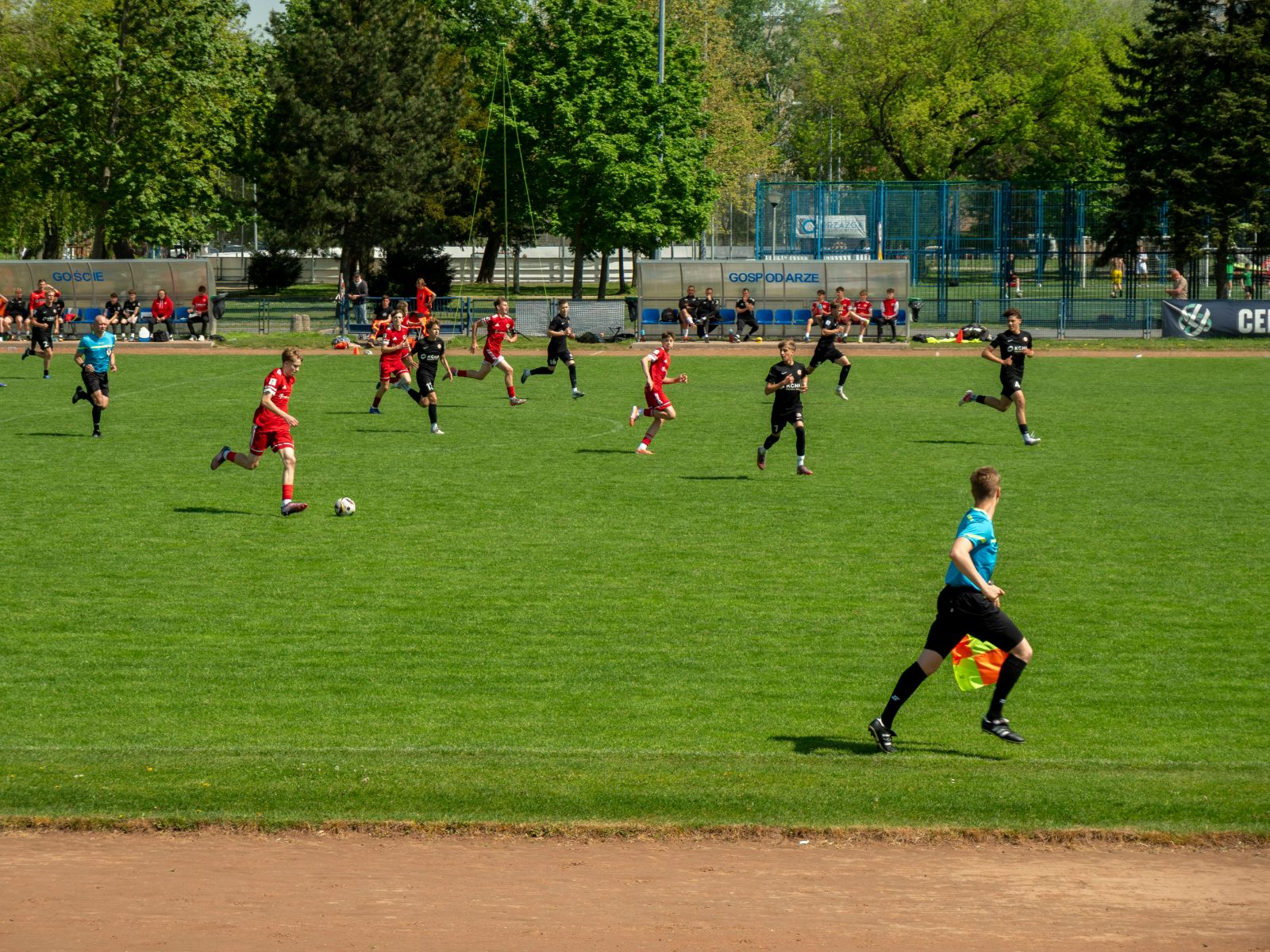 Saturday-morning grassroots football: a coach with young players on a club pitch